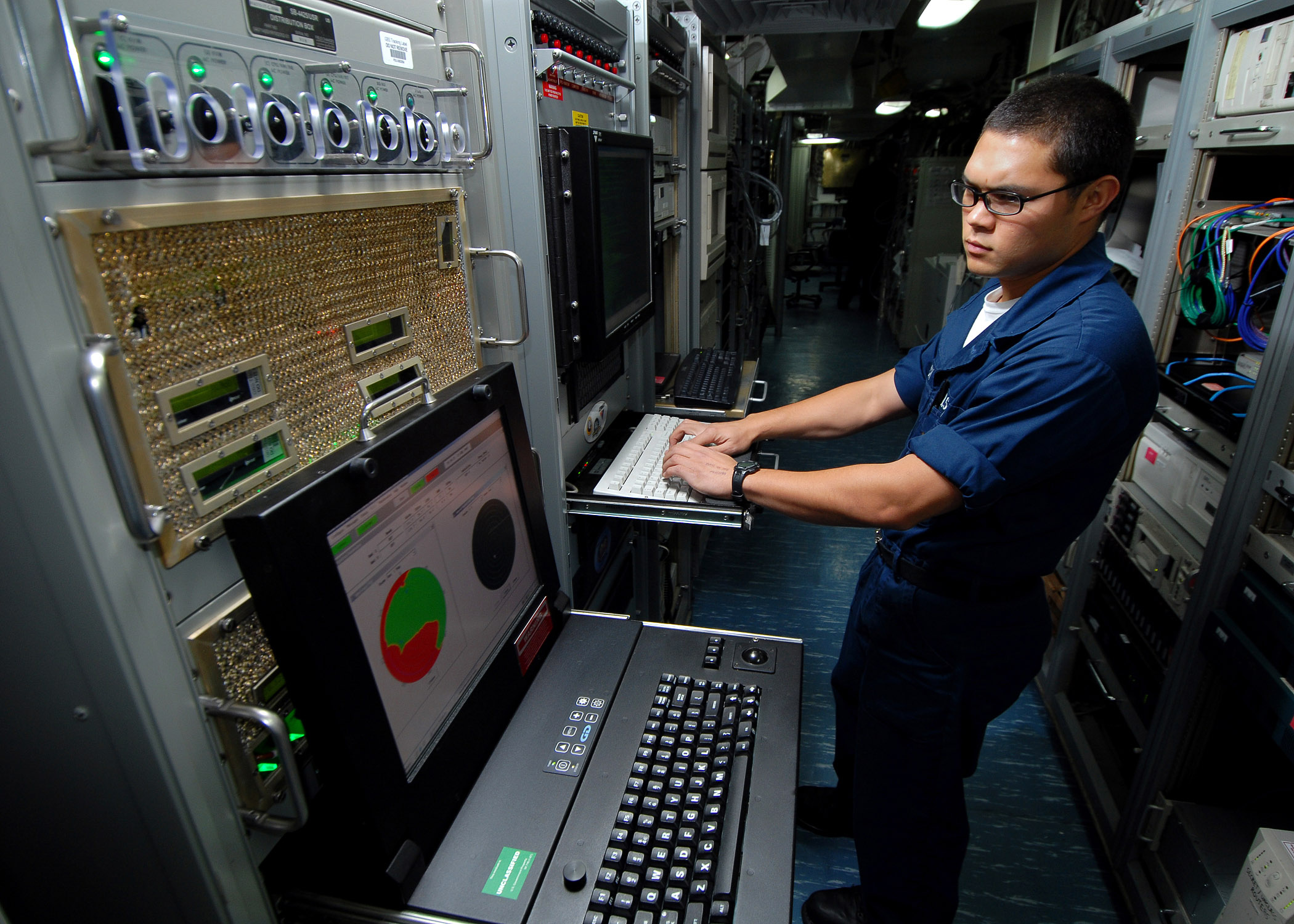 A Navy seaman monitors the ship's Automated Digital Networking System using general Digital rack mount displays